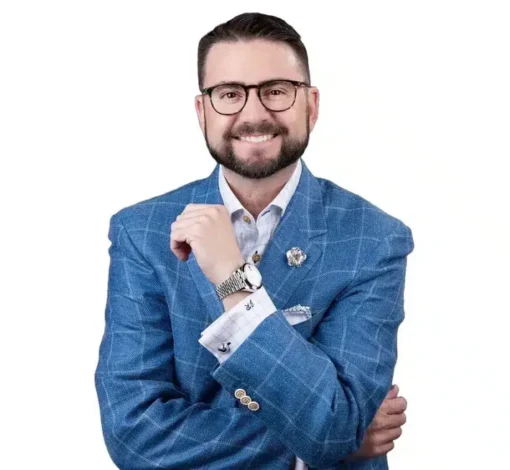 Dr. Jon Randall, Founder of XFA.COACH, smiling in a blue blazer.