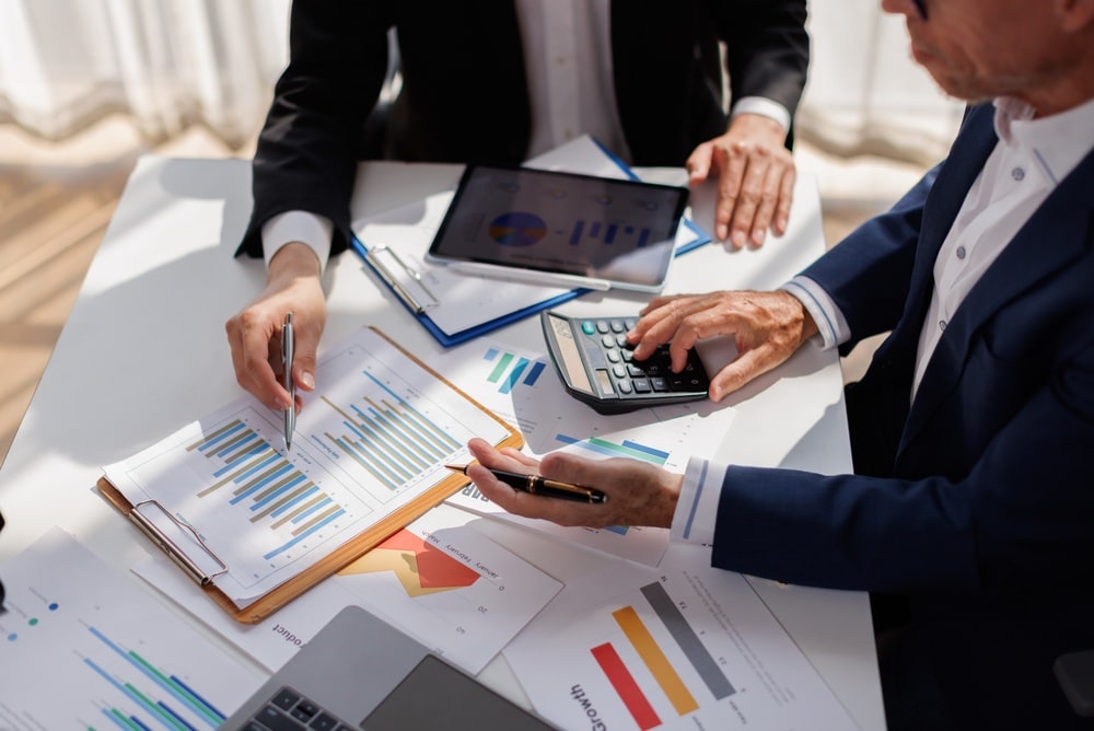 Analyze,Financial,Data,And,Accounting,Record,With,Calculator,In,Meeting