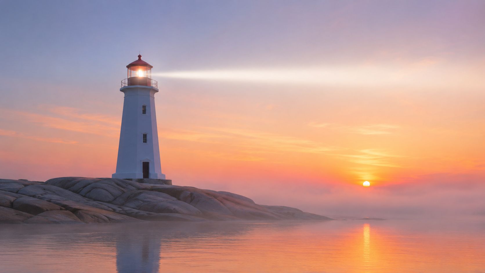 A picturesque white lighthouse on a rocky shore glowing under a beautiful orange and purple sunset sky.